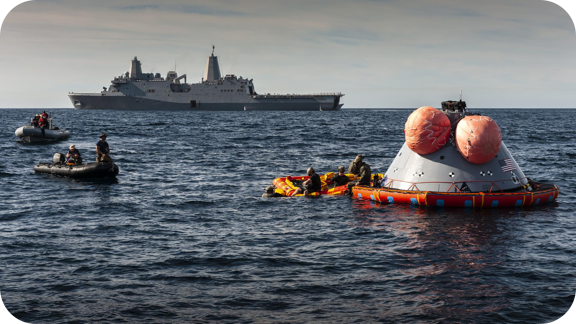 U.S. Navy divers prepare to attach the 