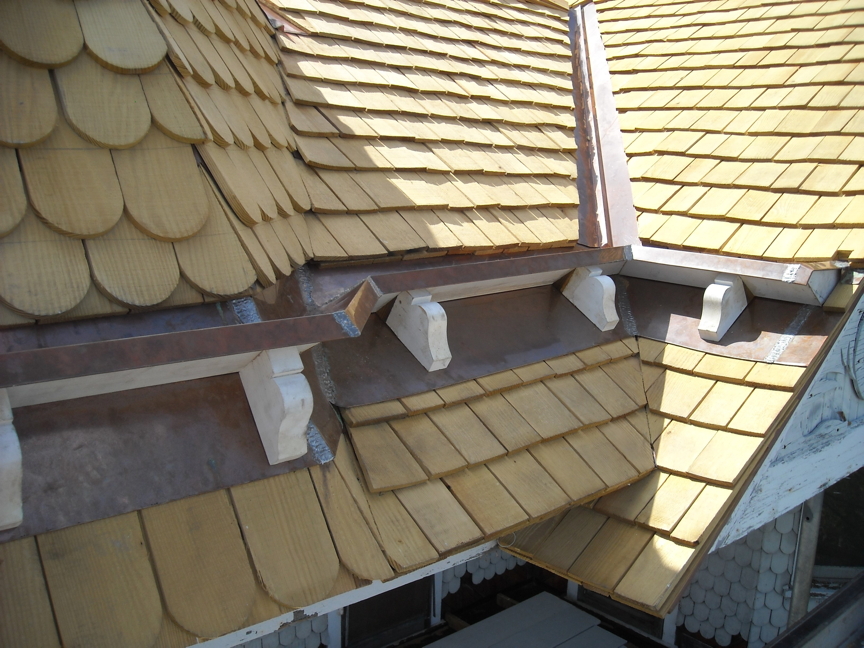 Copper clad stop gutter and channel flashing with new shingles. Copper clad stop gutter and channel flashing with new shingles.