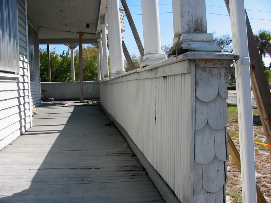 Downstairs side porch before restoration.